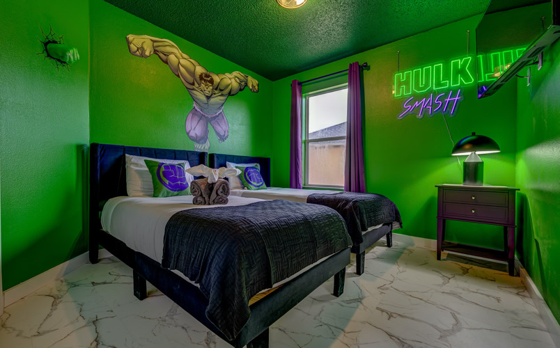 Green Hulk themed twin bedroom with neon wall art at Marble Studios Florida in Kissimmee