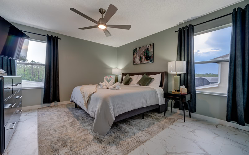 Tranquil king bedroom with large windows and modern decor at Marble Studios Florida in Kissimmee